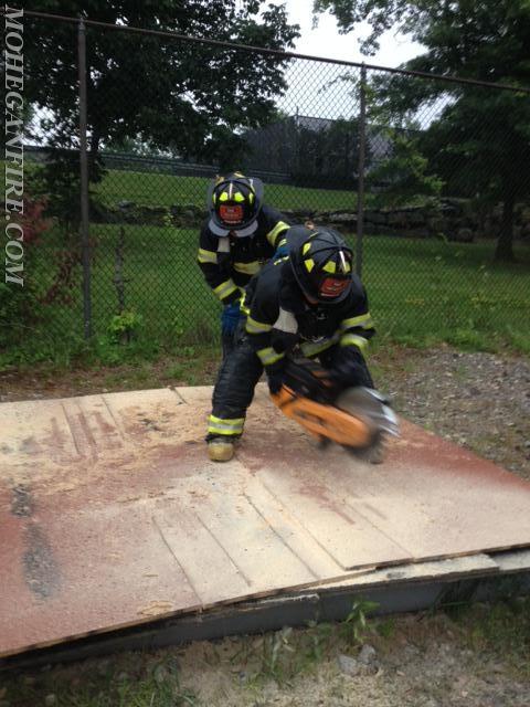 Probationary Firefighters Performing Roof Ventilation Training At Westchester County Fire Training Center On 7/15/14